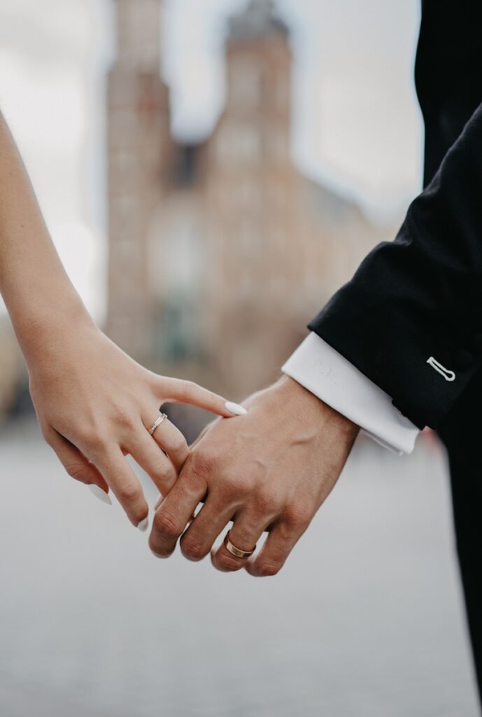 A close up of two people holding hands