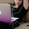 woman sitting on sofa with MacBook Air