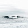 waves under cloudy sky during daytime