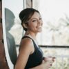 smiling woman in front of window